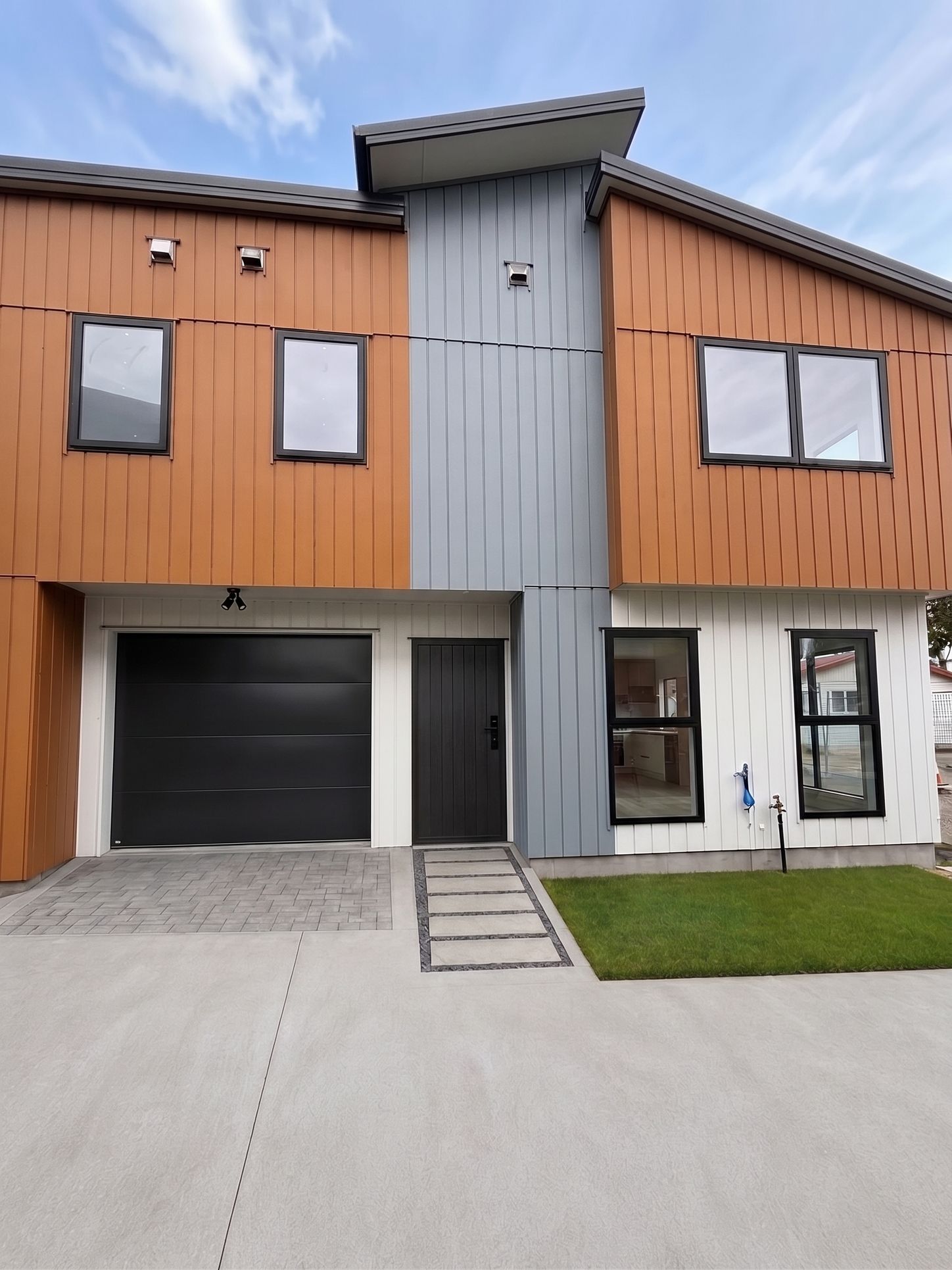 Digitally altered exterior with proposed paving, lawn and finished doors